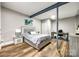 Cozy bedroom featuring stylish wood floors, a comfortable bed, and a functional desk area at 341 Fischer Rd, Fort Mill, SC 29715