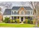Charming two-story home with stone accents, black shutters, and lush landscaping at 341 Fischer Rd, Fort Mill, SC 29715