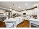 Bright kitchen with large island, stainless appliances, quartz counters and wood flooring at 341 Fischer Rd, Fort Mill, SC 29715
