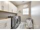 Functional laundry room features modern appliances, ample storage, and stylish decor with custom floor mat at 341 Fischer Rd, Fort Mill, SC 29715