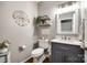 Chic powder room with decorative mirror, shelving and dark vanity at 341 Fischer Rd, Fort Mill, SC 29715