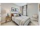 Cozy bedroom featuring a comfortable queen bed, stylish decor, and ample natural light from the window at 348 Catawba Ave, Davidson, NC 28036