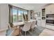 Bright dining area features a modern table set, stylish decor, and plenty of natural light from large windows at 348 Catawba Ave, Davidson, NC 28036