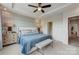 Spacious main bedroom with tray ceiling, elegant decor, and a comfortable king-sized bed with stylish bedding at 348 Catawba Ave, Davidson, NC 28036