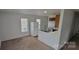 Open-concept kitchen with white appliances, stainless steel sink, and adjoins a cozy carpeted living area at 351 Haigler St, Rock Hill, SC 29732