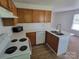 Kitchen features oak cabinets, white countertops, and modern appliances for an eat-in kitchen experience at 351 Haigler St, Rock Hill, SC 29732