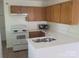 Bright kitchen featuring oak cabinets, white countertops and appliances with a stainless steel faucet at 351 Haigler St, Rock Hill, SC 29732