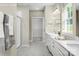 Elegant bathroom with double sinks, walk-in shower, and a view into an organized walk in closet at 508 Kenyon Dr, Denver, NC 28037