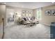 Cozy loft featuring a comfortable sofa, a small table, and an inviting view of a bedroom through an open doorway at 508 Kenyon Dr, Denver, NC 28037