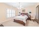 This bedroom includes a ceiling fan, shutters, and neutral carpet at 5101 Belicourt Dr, Charlotte, NC 28277