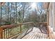 Wooden deck with natural railing overlooks a lush green backyard with mature trees at 5101 Belicourt Dr, Charlotte, NC 28277