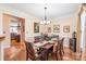 Elegant dining room featuring hardwood floors, decorative lighting, and ample seating at 5101 Belicourt Dr, Charlotte, NC 28277