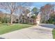 Lovely brick home boasts a well-maintained lawn, mature trees and a side entry three-car garage at 5101 Belicourt Dr, Charlotte, NC 28277
