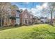 Beautiful two-story brick home with a well-manicured lawn and manicured shrubbery at 5101 Belicourt Dr, Charlotte, NC 28277