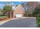 Charming brick home featuring a two-car garage and a spacious driveway perfect for additional parking at 5101 Belicourt Dr, Charlotte, NC 28277