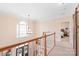 Bright hallway featuring hardwood floors, staircase, and stylish lighting fixture at 5101 Belicourt Dr, Charlotte, NC 28277