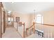 A second floor hallway shows the stairs to the entry and open floor plan at 5101 Belicourt Dr, Charlotte, NC 28277