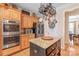 Kitchen area featuring granite countertops, stainless steel appliances, wooden cabinetry, and an island at 5101 Belicourt Dr, Charlotte, NC 28277