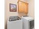 Laundry room featuring modern washer and dryer units and ample storage cabinets at 5101 Belicourt Dr, Charlotte, NC 28277