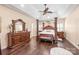 This main bedroom includes a coffered ceiling, ceiling fan, and a large four post bed at 5101 Belicourt Dr, Charlotte, NC 28277