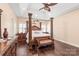 An alternative view of this main bedroom includes a four post bed and wood flooring at 5101 Belicourt Dr, Charlotte, NC 28277