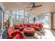 Bright sunroom with lots of windows, tile floors, a ceiling fan and comfortable seating at 5101 Belicourt Dr, Charlotte, NC 28277