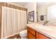 Cozy bathroom featuring a neutral shower curtain, framed artwork, and vanity with sink at 599 Sixth Baxter Xing, Fort Mill, SC 29708