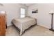 This bedroom offers neutral walls, carpet, and a side table with a lamp at 599 Sixth Baxter Xing, Fort Mill, SC 29708