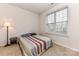 Comfortable bedroom with a window, neutral walls, and furnished with a bed and side table at 599 Sixth Baxter Xing, Fort Mill, SC 29708