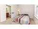 Comfortable bedroom with a connected bathroom, neutral walls, and furnished with a bed and side table at 599 Sixth Baxter Xing, Fort Mill, SC 29708