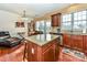 The kitchen has a granite island, stainless steel appliances, and wood cabinets at 599 Sixth Baxter Xing, Fort Mill, SC 29708