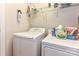 Efficient laundry area with washer, dryer, shelving, and necessary cleaning supplies at 599 Sixth Baxter Xing, Fort Mill, SC 29708