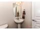 The powder room includes a pedestal sink, neutral walls, and modern fixtures at 599 Sixth Baxter Xing, Fort Mill, SC 29708