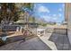 Fenced backyard with a chicken coop and a white table, offering a functional and charming outdoor space at 7200 Morning Dew Ct, Denver, NC 28037