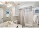 Well-lit bathroom with a single sink vanity, toilet, and a shower with a curtain, maximizing the small space at 7200 Morning Dew Ct, Denver, NC 28037