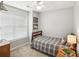 Simple bedroom with a twin-size bed, neutral walls, and a window with blinds, providing natural light at 7200 Morning Dew Ct, Denver, NC 28037