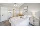 Bright bedroom with a ceiling fan, and a cozy queen-size bed with stylish side tables and lamps at 7200 Morning Dew Ct, Denver, NC 28037