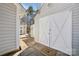 Exterior view of a white garage with double doors and a 