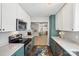 Bright kitchen showcasing modern appliances, stone countertops, and a view into the living area at 7200 Morning Dew Ct, Denver, NC 28037