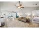 Cozy living room featuring hardwood floors, ceiling fan, and seamless transition to the dining area and kitchen at 7200 Morning Dew Ct, Denver, NC 28037