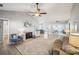 Bright living room featuring a fireplace, ceiling fan, and neutral color palette at 7200 Morning Dew Ct, Denver, NC 28037