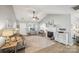 Living room showcasing the fireplace, hardwood floors, and ample natural light at 7200 Morning Dew Ct, Denver, NC 28037