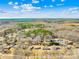 Expansive aerial view of a neighborhood surrounded by lush, mature trees and beautiful blue skies at 827 Lakeside Cir, Lancaster, SC 29720