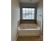 Bright bathroom featuring a large soaking tub, tile surround, and window at 8833 Goldfields Dr, Charlotte, NC 28227