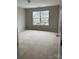 Bedroom featuring neutral colors and a large window providing natural light at 8833 Goldfields Dr, Charlotte, NC 28227