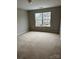 Bedroom with a large window providing natural light and neutral walls at 8833 Goldfields Dr, Charlotte, NC 28227