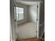 An empty bedroom awaits personalization, featuring neutral carpeting and a bright, sunlit window at 8833 Goldfields Dr, Charlotte, NC 28227