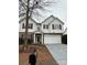 Charming two-story home boasts a stone accent and a large, attached two-car garage at 8833 Goldfields Dr, Charlotte, NC 28227