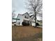 Corner lot two story home features siding and stone details, a two-car garage, and mature trees at 8833 Goldfields Dr, Charlotte, NC 28227