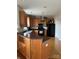 Functional kitchen with wood cabinetry, black appliances, breakfast bar, and durable countertops at 8833 Goldfields Dr, Charlotte, NC 28227